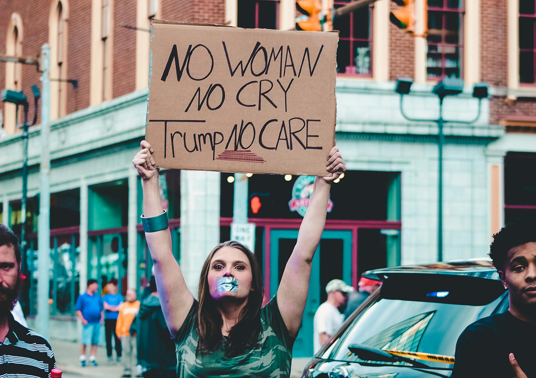 woman holding cardboard signage